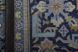 Backside of handmade 2000s Kashan rug showing knot structure and weave density