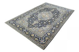 Corner detail of 2000s Kashan rug showing border pattern and Wool pile