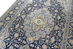 Backside of handmade 2000s Kashan rug showing knot structure and weave density