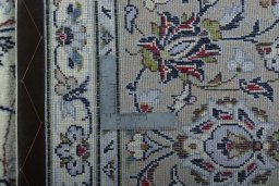 Backside of handmade 2000s Kashan rug showing knot structure and weave density