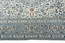Corner detail of 2000s Kashan rug showing border pattern and Wool pile