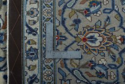 Backside of handmade 2000s Kashan rug showing knot structure and weave density