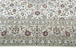 Corner detail of 2000s Kashan rug showing border pattern and Wool pile