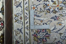 Backside of handmade 2000s Kashan rug showing knot structure and weave density