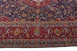 Corner detail of 2000s Kashan rug showing border pattern and Wool pile