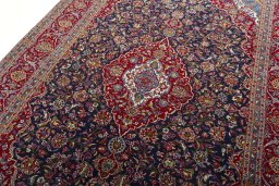 Backside of handmade 2000s Kashan rug showing knot structure and weave density