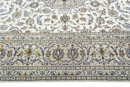 Corner detail of 2000s Kashan rug showing border pattern and Wool pile