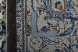 Backside of handmade 2000s Kashan rug showing knot structure and weave density