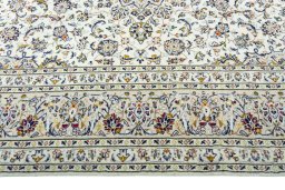 Corner detail of 2000s Kashan rug showing border pattern and Wool pile