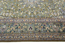 Corner detail of 2000s Kashan rug showing border pattern and Wool pile