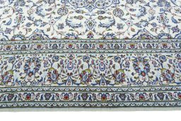 Corner detail of 2000s Kashan rug showing border pattern and Wool pile