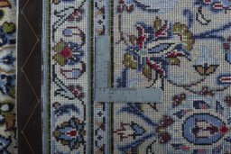 Backside of handmade 2000s Kashan rug showing knot structure and weave density
