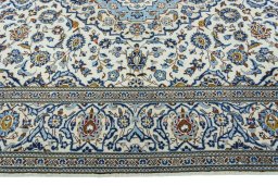 Corner detail of 2000s Kashan rug showing border pattern and Wool pile