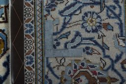 Backside of handmade 2000s Kashan rug showing knot structure and weave density