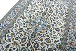 Backside of handmade 2000s Kashan rug showing knot structure and weave density