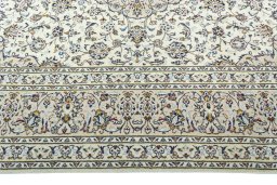 Corner detail of 2000s Kashan rug showing border pattern and Wool pile