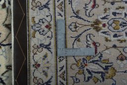 Backside of handmade 2000s Kashan rug showing knot structure and weave density