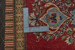 Backside of handmade New Kashan rug showing knot structure and weave density
