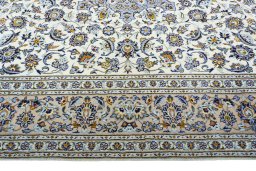 Corner detail of 2000s Kashan rug showing border pattern and Wool pile