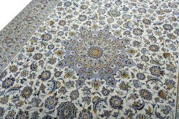 Backside of handmade 2000s Kashan rug showing knot structure and weave density