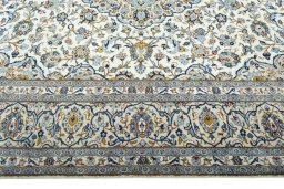 Corner detail of 2000s Kashan rug showing border pattern and Wool pile