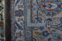 Backside of handmade 2000s Kashan rug showing knot structure and weave density