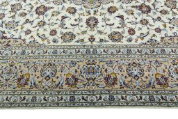 Corner detail of 2000s Kashan rug showing border pattern and Wool pile