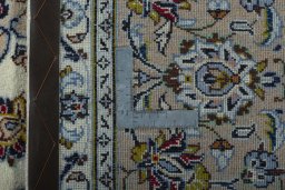 Backside of handmade 2000s Kashan rug showing knot structure and weave density
