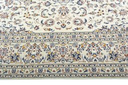 Corner detail of 2000s Kashan rug showing border pattern and Wool pile
