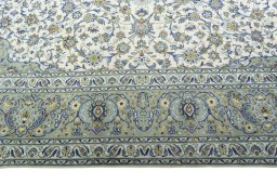 Corner detail of 2000s Kashan rug showing border pattern and Cork pile