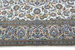 Corner detail of 2000s Kashan rug showing border pattern and Wool pile