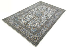 Corner detail of 2000s Kashan rug showing border pattern and Wool pile