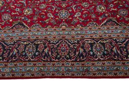 Corner detail of 2000s Kashan rug showing border pattern and Wool pile