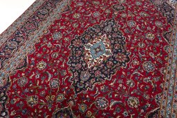 Backside of handmade 2000s Kashan rug showing knot structure and weave density