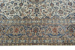 Corner detail of 2000s Kashan rug showing border pattern and Wool pile