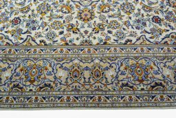 Corner detail of 2000s Kashan rug showing border pattern and Wool pile