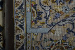 Backside of handmade 2000s Kashan rug showing knot structure and weave density