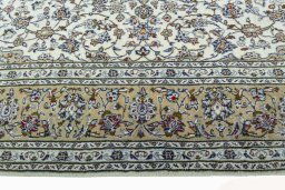 Corner detail of 2000s Kashan rug showing border pattern and Wool pile