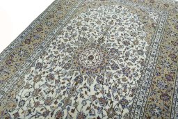 Backside of handmade 2000s Kashan rug showing knot structure and weave density