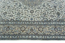 Corner detail of 2000s Kashan rug showing border pattern and Wool pile