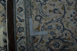 Backside of handmade 2000s Kashan rug showing knot structure and weave density