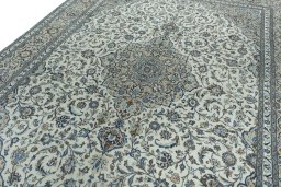 Backside of handmade 2000s Kashan rug showing knot structure and weave density