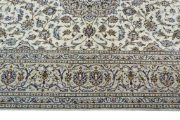 Corner detail of 2000s Kashan rug showing border pattern and Wool pile