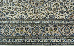 Corner detail of 2000s Kashan rug showing border pattern and Wool pile
