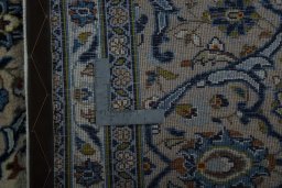 Backside of handmade 2000s Kashan rug showing knot structure and weave density