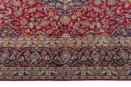 Corner detail of 2000s Kashan rug showing border pattern and Wool pile