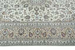 Corner detail of 2000s Kashan rug showing border pattern and Wool pile