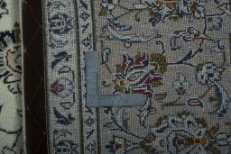 Backside of handmade 2000s Kashan rug showing knot structure and weave density
