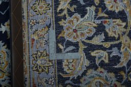 Backside of handmade 1970s Kashan rug showing knot structure and weave density