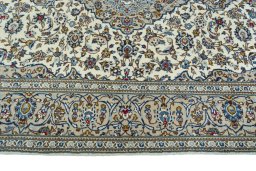 Corner detail of 2000s Kashan rug showing border pattern and Wool pile